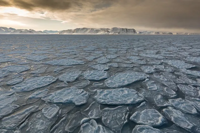 “March is a great time to visit the Norwegian archipelago of Svalbard. The sun has returned but, having not yet reached its polar summer heights, provides soft light for most of the day. This was taken as we sailed through the early formation of sea ice, known as “pancake ice”. (Photo by Kellie Netherwood/The Guardian)