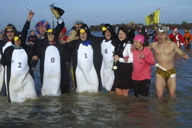 People wearing costumes participate in a traditional New Year's Day swim in Dunkirk, northern France, January 1, 2016. (Photo by Pascal Rossignol/Reuters)