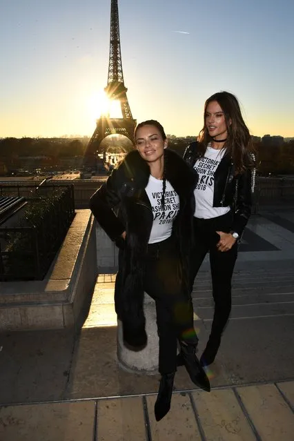Adriana Lima and Alessandra Ambrosio pose in front of the Eiffel Tower prior the 2016 Victoria's Secret Fashion Show on November 29, 2016 in Paris, France. (Photo by Dimitrios Kambouris/Getty Images for Victoria's Secret)