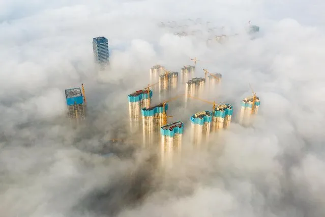 Aerial view of buildings surrounded by dense fog on April 13, 2021 in Nanchang, Jiangxi Province of China. (Photo by Ma Gang/VCG via Getty Images)
