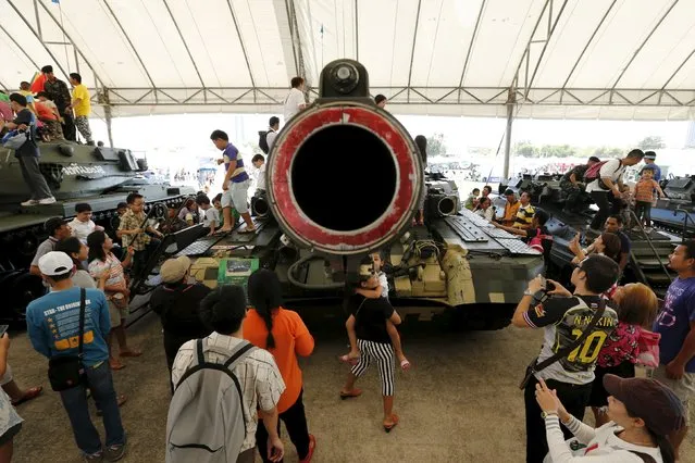 Children play on the top of a tank during the Children's Day celebration at a military facility in Bangkok, Thailand January 9, 2016. (Photo by Jorge Silva/Reuters)