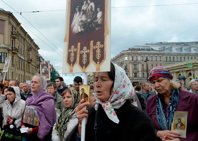 Russian Orthodox clergy and believers participate in a procession in central Saint Petersburg on September 12, 2018. A procession marks the 294 th anniversary of the transfer of the relics of St. Alexander Nevsky, who is considered to be a heavenly protector of Saint Petersburg. (Photo by Olga Maltseva/AFP Photo)