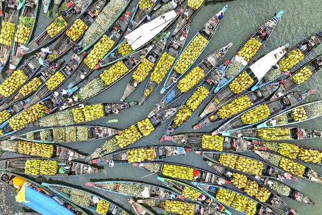 Fruit being transported by boat to a floating market in Chattogram, Bangladesh in the last decade of July 2023. (Photo by Sabina Akter/Solent News)