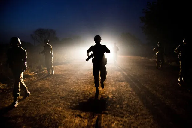 Peacekeeper troops from Ethiopia and deployed in the United Nations (UN) Interim Security Force for Abyei (UNISFA) patrol at night in Abyei town, Abyei state, on December 14, 2016. The Abyei Administrative Area is a disputed territory between Sudan and South Sudan with a longstanding intercommunal tensions between the Ngok-Dinka ethnic majority and the pastoral Misseriya population, who migrate through the area seasonally from the north. An attack by Government of Sudan forces on Abyei in May 2011 displaced the majority of the Ngok Dinka population, approximately 105,000 people to areas south of the River Kiir, which became overcrowded and are suffering a huge competition over natural resources. (Photo by Albert Gonzalez Farran/AFP Photo)