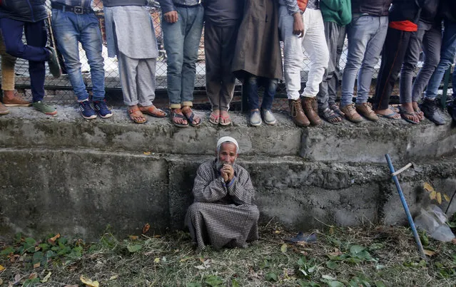 An elderly Kashmiri villager cries during the funeral of Uzair Mushtaq in Kulgam 75 Kilometers south of Srinagar, Indian controlled Kashmir, Sunday, October 21, 2018. Three local rebels were killed in a gunbattle with Indian government forces in disputed Kashmir on Sunday, and six civilians were killed in an explosion at the site after the fighting was over, officials and residents said. (Photo by Mukhtar Khan/AP Photo)