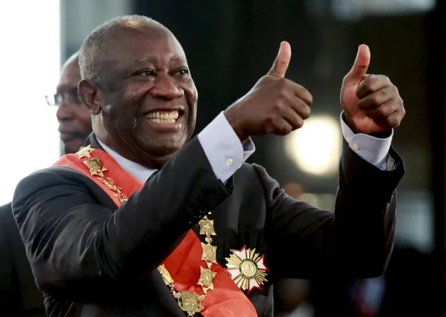 Ivory Coast's President Laurent Gbagbo flashes two thumbs-up during his inauguration at the presidential palace in Abidjan December 4, 2010. (Photo by Thierry Gouegnon/Reuters)