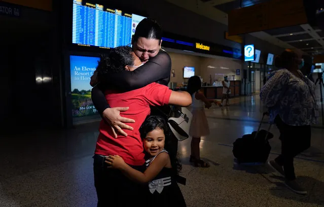 Emely, left, is reunited with her mother, Glenda Valdez and sister, Zuri, at Austin-Bergstrom International Airport, Sunday, June 6, 2021, in Austin, Texas. It had been six years since Valdez said goodbye to her daughter Emely in Honduras. Then, last month, she caught a glimpse of a televised Associated Press photo of a little girl in a red hoodie and knew that Emely had made the trip alone into the United States. On Sunday, the child was returned to her mother’s custody. (Photo by Eric Gay/AP Photo)