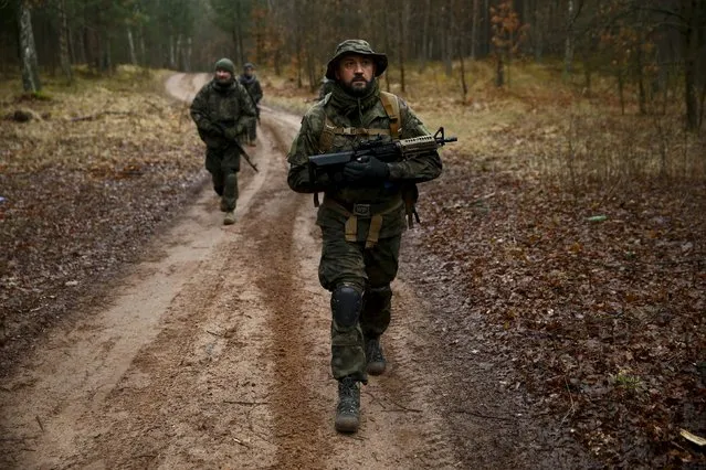 Robert Przybyl takes part in an endurance march during a territorial defence training organised by paramilitary group SJS Strzelec (Shooters Association) in the forest near Minsk Mazowiecki, eastern Poland March 14, 2014. (Photo by Kacper Pempel/Reuters)