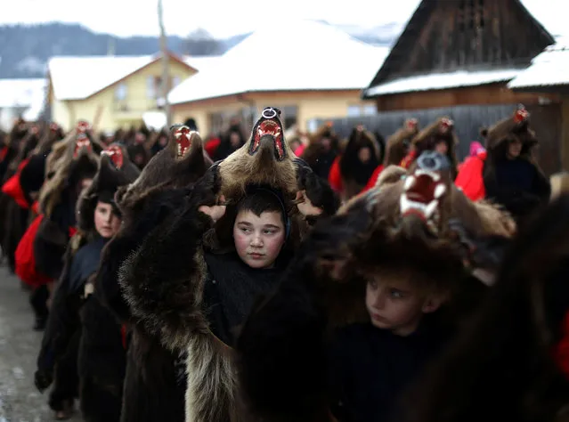 Dancers wearing costumes made of bearskins dance in the village of Asau, Romania December 30, 2016. (Photo by Stoyan Nenov/Reuters)