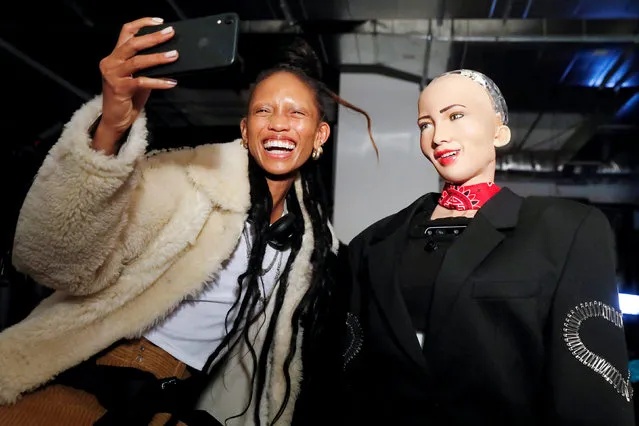 Model Adesuwa Aighewi takes a selfie as she is interviewed by Sophia, a humanoid robot created by Hanson Robotics, backstage before the “Alexander Wang Collection 2” presentation in Brooklyn, New York City, U.S., December 1, 2018. (Photo by Andrew Kelly/Reuters)