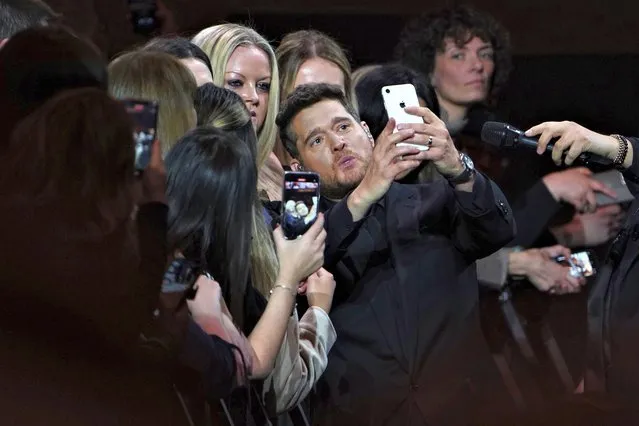 Canadian singer Michael Buble poses for a selfie as he performs on stage at the O2 Arena in London, Sunday, March 26, 2022. (Photo by Scott Garfitt/Invision/AP Photo)