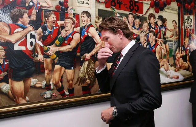 Bombers head coach James Hird walks past a painting dedicated to the 1984 and 1985 premiership teams before his press conference at Essendon Bombers headquarters after Essendon players were found not guilty from the AFL's anti-doping tribunal today from the investigation into alleged use of banned substances on March 31, 2015 in Melbourne, Australia. (Photo by Michael Dodge/Getty Images)