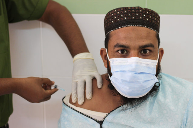 Medical staff administering the dose of Moderna COVID-19 Vaccine at the M A G Osmani Medical College & Hospital vaccination center in Sylhet, Bangladesh on July 26, 2021. (Photo by Md Rafayat Haque Khan/ZUMA Press Wire/Rex Features/Shutterstock)