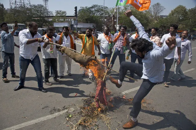 Activists of Bharatiya Janata Yuva Morcha (BJYM) burn a symbolic effigy of Pakistan and shout slogans against Thursday's attack on a paramilitary convoy in Kashmir, in Hyderabad, India, Friday, February 15, 2019. The death toll from a car bombing on a paramilitary convoy in Indian-controlled Kashmir has climbed to at least 40, becoming the single deadliest attack in the divided region's volatile history, security officials said Friday. (Photo by Mahesh Kumar A./AP Photo)