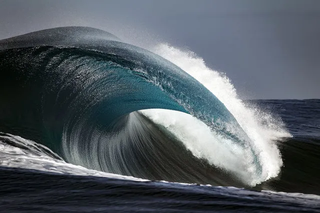 A shot of a wave crashing down into the ocean in the clear waters of Teahupoo. (Photo by Ben Thouard/Caters News)