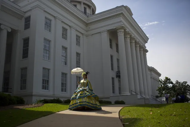 United Daughters of the Confederacy member, Carrie McGough, of Titus, Ala., walks in front of the Alabama Capitol building during a confederate memorial day ceremony Monday, April 27, 2015, in Montgomery, Ala. (Photo by Brynn Anderson/AP Photo)