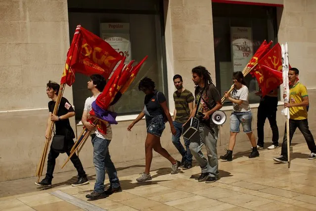 People carry a Second Spanish Republic flag and Communist flags after a May Day rally in Malaga, Spain May 1, 2015. (Photo by Jon Nazca/Reuters)