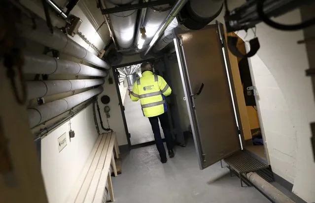 Tour guide Hans-Juergen Haite leads the way through a Federal reserve bank (Bundesbank) bunker prior to the bunker's official opening to the public in Cochem, Germany, March 18, 2016. (Photo by Kai Pfaffenbach/Reuters)