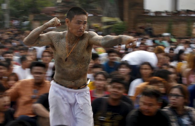 A devotee in a state of trance mimics creatures tattooed on his body during the annual Magic Tattoo Festival at Wat Bang Phra in Nakhon Pathom province, on the outskirts of Bangkok, Thailand, March 19, 2016. (Photo by Chaiwat Subprasom/Reuters)