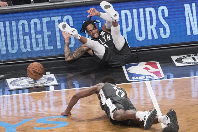 Brooklyn Nets guard D'Angelo Russell, top, and guard Caris LeVert (22) fall on the court during the second half of Game 4 of a first-round NBA basketball playoff series against the Philadelphia 76ers, Saturday, April 20, 2019, in New York. (Photo by Mary Altaffer/AP Photo)
