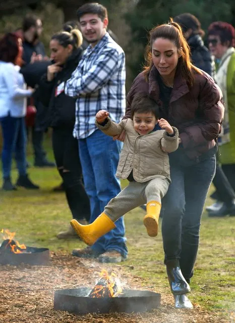 People leap over a bonfire during a fire festival at Ambleside Park in West Vancouver, British Columbia, Canada, on March 12, 2024. The festival was held by the local Iranian community to celebrate the upcoming Nowruz, the Iranian New Year. (Photo by Xinhua News Agency/Rex Features/Shutterstock)