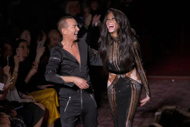 Canadian model Winnie Harlow, right, and designer Julien Macdonald acknowledge applause after his Autumn/Winter 2017 show, as part of London Fashion Week, Saturday, February 18, 2017. (Photo by Joel Ryan/Invision/AP Photo)