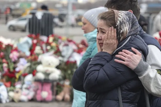 People mourn at the Crocus City Hall concert venue following a terrorist attack in Krasnogorsk, outside Moscow, Russia, 25 March 2024. At least 137 people were killed and more than 100 hospitalized after a group of gunmen attacked the concert hall in the Moscow region on 22 March evening, Russian officials said. Eleven suspects, including all four gunmen directly involved in the terrorist attack, have been detained, according to Russian authorities. (Photo by Maxim Shipenkov/EPA/EFE)
