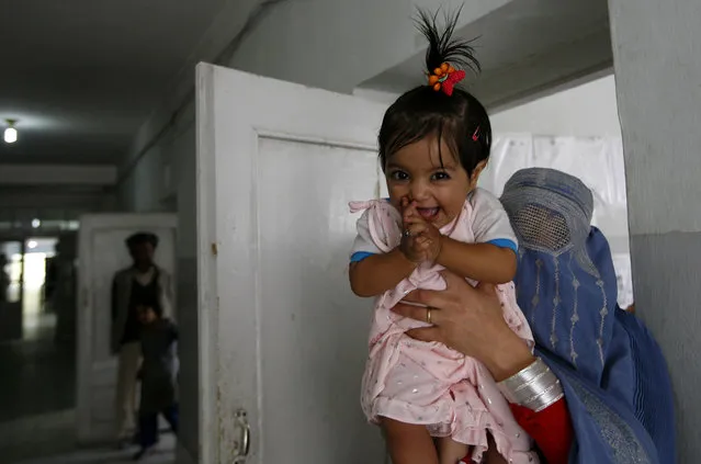 An Afghan girl reacts as she arrives with her mother for treatment in the local hospital of Feyzabad, on September 28, 2008. (Photo by Anja Niedringhaus/AP Photo)