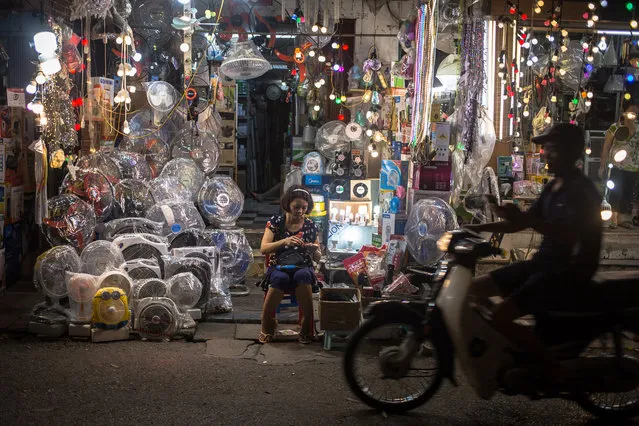 A woman sells fans and other goods at the Old Quater in Hanoi, Vietnam, 28 May 2019. (Photo by Roman Pilipey/EPA/EFE)