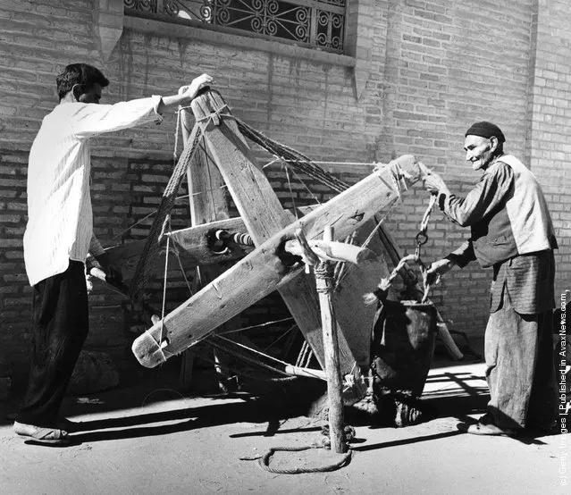 1955:  A well is dug in Yazd, Iran, using a wooden windlass and leather bag. Many of the methods and construction techniques used in Iran have not changed in a thousand years