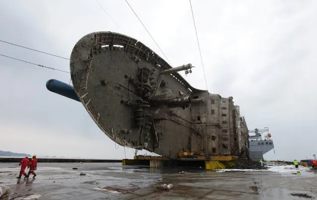 The sunken ferry Sewol sits on a semi-submersible ship during its salvage operations at the sea off Jindo, South Korea, in this handout picture provided by the Ministry of Oceans and Fisheries and released by Yonhap on March 26, 2017. (Photo by Reuters/Yonhap/The Ministry of Oceans and Fisheries)