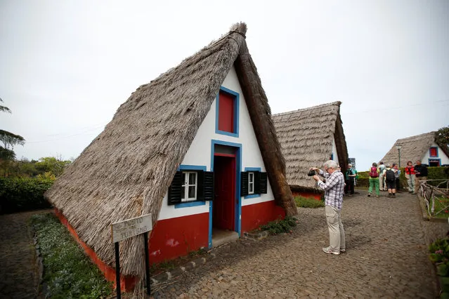 Tourists visit Madeira's traditional houses in Santana on Madeira's North coast, Portugal March 30, 2017. (Photo by Rafael Marchante/Reuters)