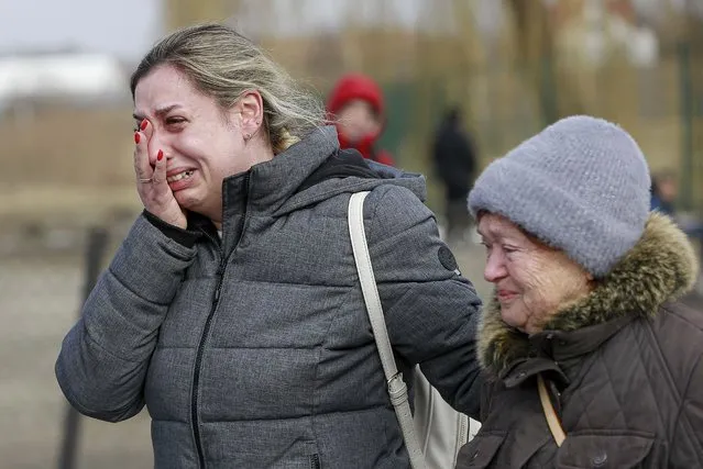 A Ukrainian woman reacts after arriving at the Medyka border crossing, in Poland, Sunday, February 27, 2022. Since Russia launched its offensive on Ukraine, more than 200,000 people have been forced to flee the country to bordering nations like Romania, Poland, Hungary, Moldova, and the Czech Republic – in what the U.N. refugee agency, UNHCR, said will have “devastating humanitarian consequences” on civilians. (Photo by Visar Kryeziu/AP Photo)