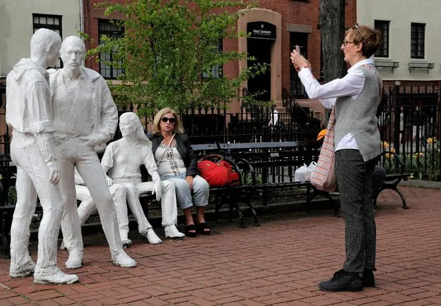 A woman photographs a sculpture called “Gay Liberation” in Christopher Park in the Greenwich Village neighborhood of New York City, U.S., May 9, 2016. (Photo by Brendan McDermid/Reuters)
