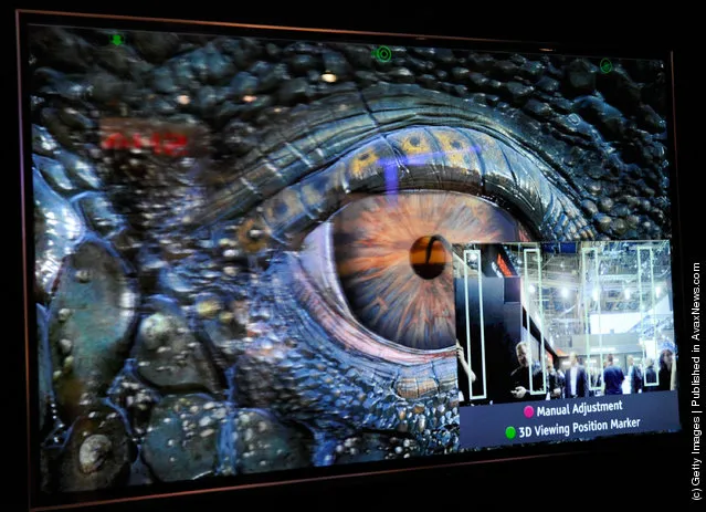 A glasses-free Toshiba 55-inch 3-D 4x full HD TV shows the movie, 'Sea Rex 3D: Journey to a Prehistoric World' at the 2012 International Consumer Electronics Show