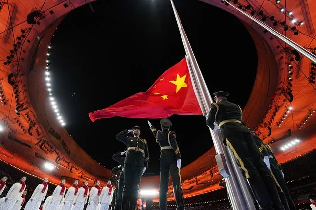 The Chinese flag is raised during the opening ceremony of the Beijing 2022 Winter Paralympics at the Beijing National Stadium on March 4, 2022 in Beijing, China. (Photo by Aly Song/Reuters)