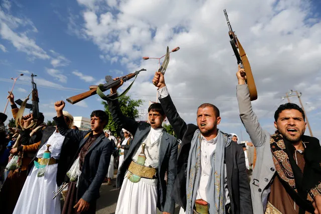 Houthi followers hold up their rifles as they shout slogans during a demonstration against the U.S. intervention in Yemen, in the country's capital Sanaa, May 13, 2016. (Photo by Khaled Abdullah/Reuters)