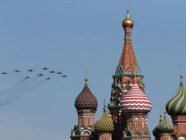 Russian military planes fly above Saint Basil's Cathedral during the Victory Day parade in Moscow's Red Square May 9, 2014. (Photo by Artur Bainozarov/Reuters)