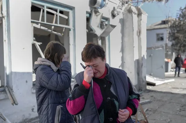 Nurses cry as they arrive to see their hospital after Russian shelling hit the mental hospital of Mykolaiv, southern Ukraine, on March 22, 2022. The southern city is a key obstacle for Russian forces trying to move west from Crimea to take Odessa, Ukraine's major port on the Black Sea. (Photo by Bulent Kilic/AFP Photo)