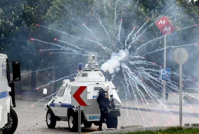 Proteters clash with Turkish police in Ankara on May 14, 2014 during a demonstration gathering hundreds after more than 200 people were killed in an explosion at a mine. Police fired tear gas and water cannon when around 800 protesters shouting slogans against the government faced police intervention attempted to march from the Middle East Technical University to the energy ministry. (Photo by Adem Altan/AFP Photo)