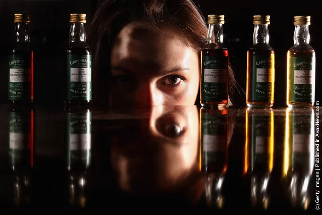 Victoria Kasperovich, an employee at McTear's Auctioneers, views a very rare collection of five Cadenhead Irish whiskey miniatures