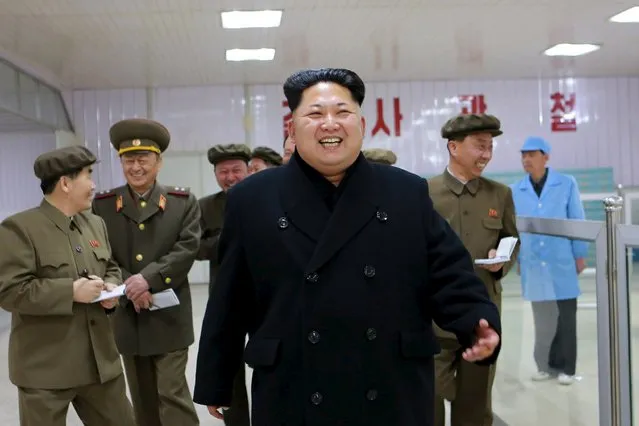 North Korean leader Kim Jong Un (front) laughs during a visit to the Pyongyang Weak-current Machine Plant, in this undated photo released by North Korea's Korean Central News Agency (KCNA) in Pyongyang on April 8, 2015. (Photo by Reuters/KCNA)