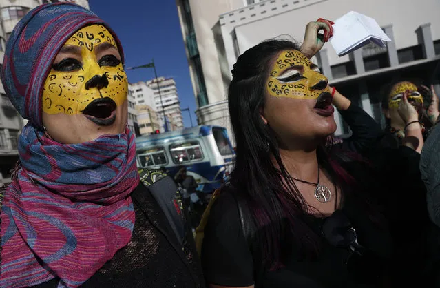 Activists with their faces painted like jaguars shout slogans that elections were a farce, as they protest the reelection of President Evo Morales, in La Paz, Bolivia, Wednesday, October 30, 2019. Bolivia’s government said Wednesday the Organization of American States is sending a 30-person team to launch a “binding” audit of a presidential election that the opposition says was manipulated to ensure the re-election of Morales. (Photo by Juan Karita/AP Photo)