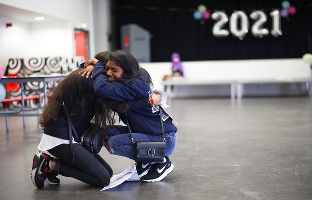 Students react after they receive their A-Level results at the Ark Academy, in London, Britain, August 10, 2021. Students across the UK are set to react after receiving their A-level exam results 10 August. High grades are expected as grades are assessed based on a wide range of evidence, due to the coronavirus pandemic. Hundreds of thousands of students are expected to apply for university with many missing out on their first choice due to fierce competition for places. (Photo by Henry Nicholls/Reuters)