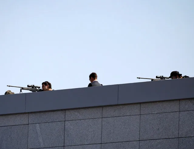 Snipers are seen atop a building prior to the arrival of Russian President Vladimir Putin in Athens, Greece airport, May 27, 2016. (Photo by Michalis Karagiannis/Reuters)