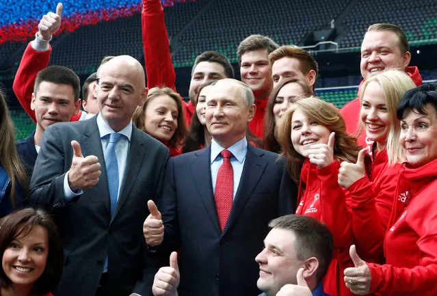 Russian President Vladimir Putin and FIFA President Gianni Infantino pose for a picture with members of Russian volunteer associations at the newly-built FC Krasnodar Stadium in the southern city of Krasnodar, Russia, May 23, 2017. (Photo by Sergei Karpukhin/Reuters)
