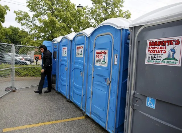 An Elvis Presley tribute artist leaves a portable toilet at the four-day Collingwood Elvis Festival in Collingwood, Ontario July 25, 2015. (Photo by Chris Helgren/Reuters)