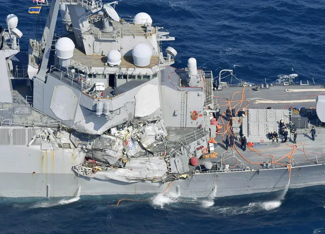The damage of the right side of the USS Fitzgerald is seen off Shimoda, Shizuoka prefecture, Japan, after the Navy destroyer collided with a merchant ship, Saturday,  June 17, 2017.  The U.S. Navy says the USS Fitzgerald suffered damage below the water line on its starboard side after it collided with a Philippine-flagged merchant ship. (Photo by Iori Sagisawa/Kyodo News via AP Photo)
