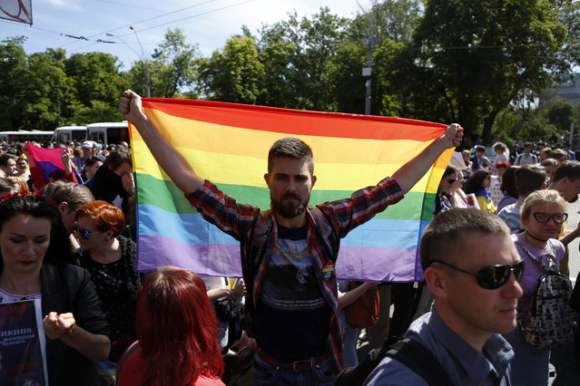 Ukrainian gay rights activists take part in a march in Kiev, Ukraine, Sunday, June 12, 2016. About one thousand gay rights activists marched in central Kiev on Sunday. (Photo by Sergei Chuzavkov/AP Photo)