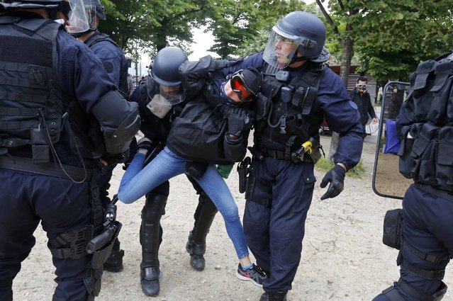 French CRS riot police apprehend a demonstrator during clashes at the Invalides square during a demonstration in Paris as part of nationwide protests against plans to reform French labour laws, France, June 14, 2016. (Photo by Jacky Naegelen/Reuters)